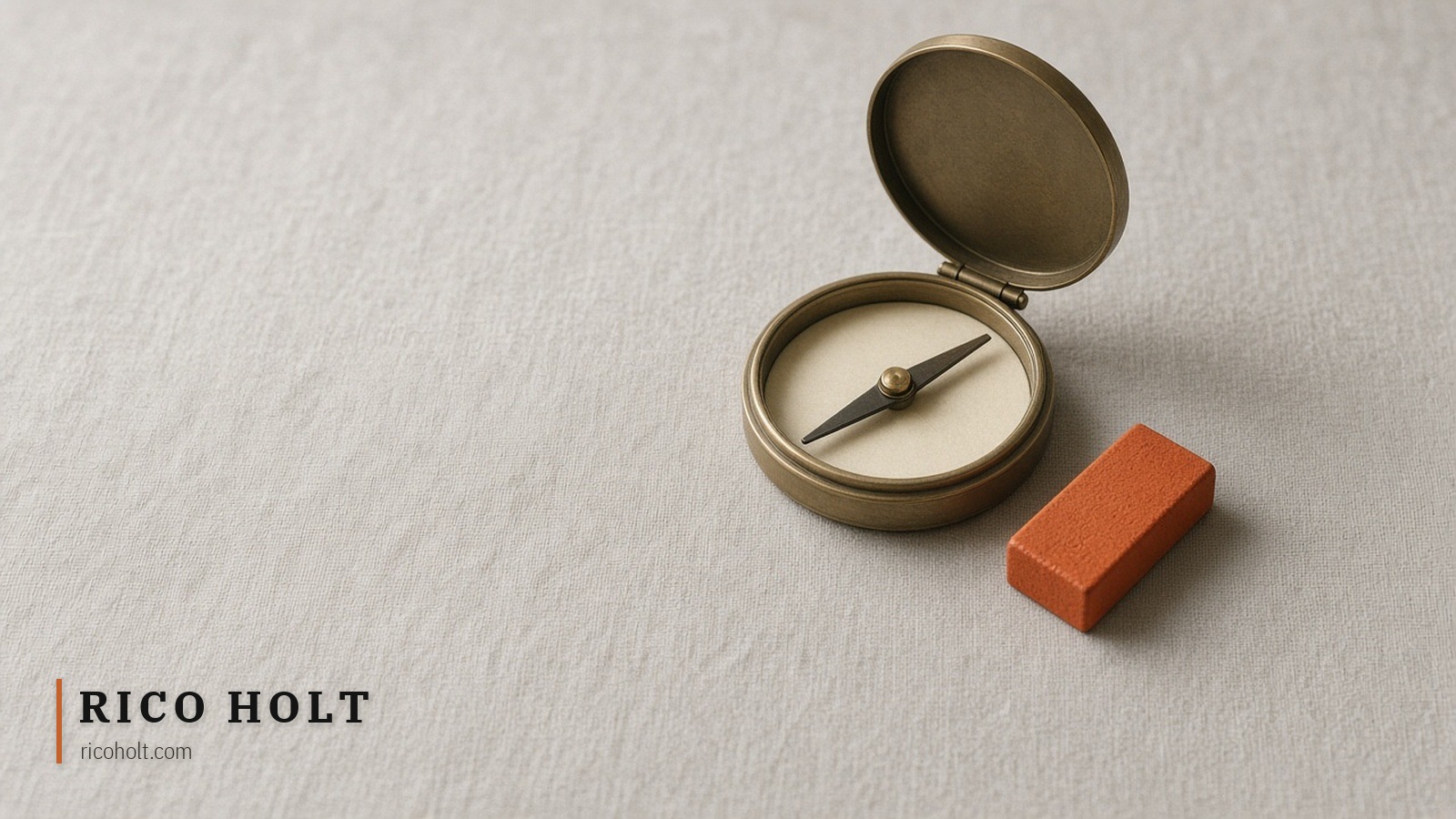 A brass pocket compass on linen with an ochre bar magnet beside it, needle swung a few degrees toward the magnet