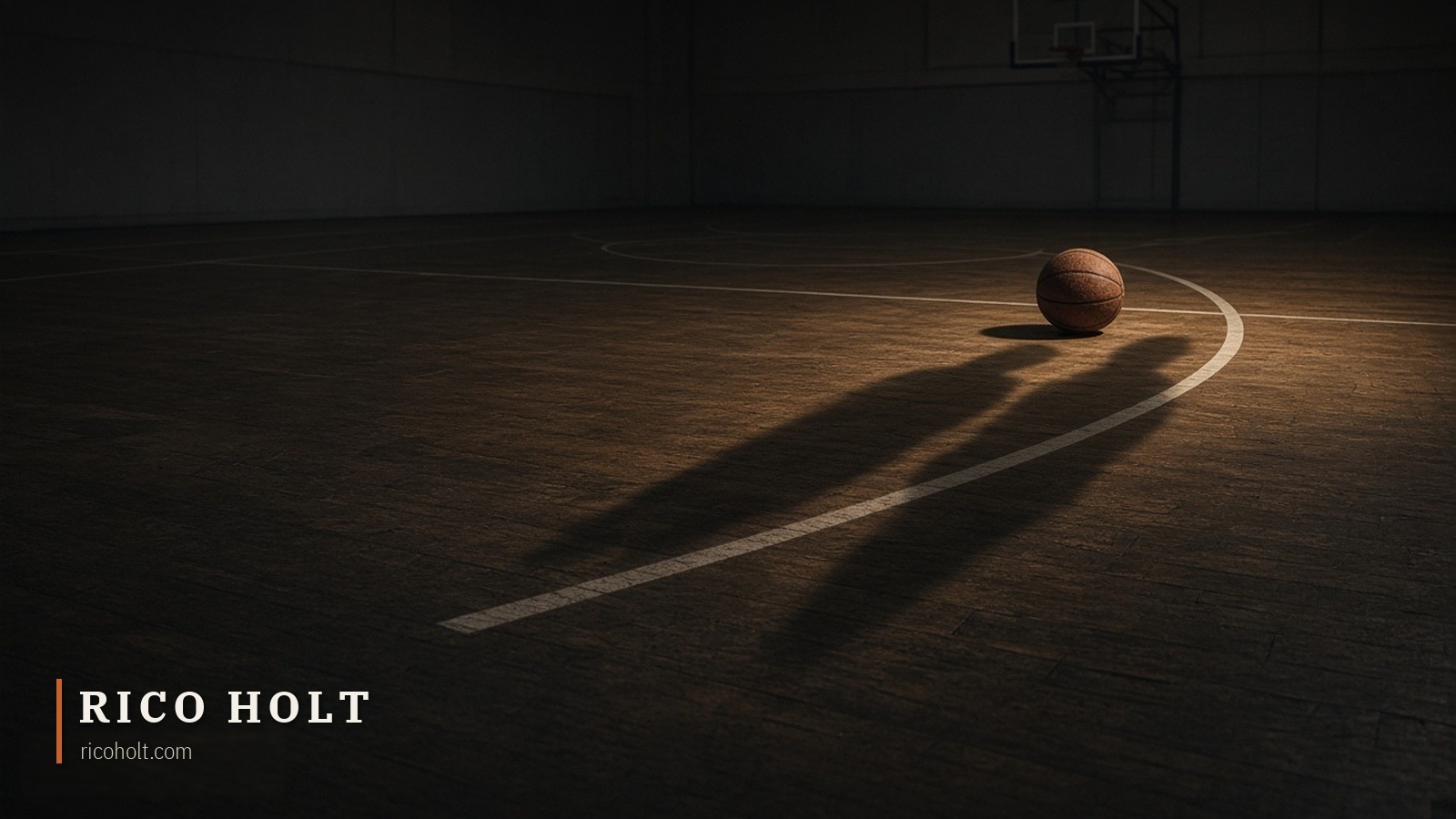An empty basketball court at night with a lone ball near the three-point arc and two long shadows of unseen defenders falling across the floor