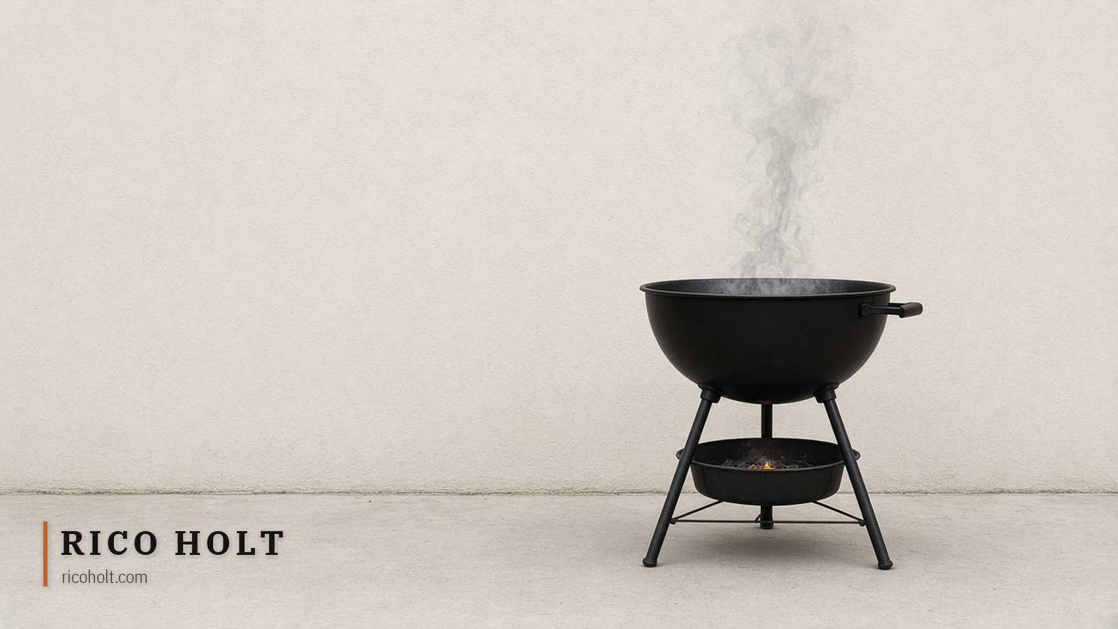 An empty black kettle barbecue smoking against a pale wall